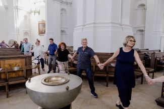 Menschen gehen an den Händen gefasst durch die Stephanskirche