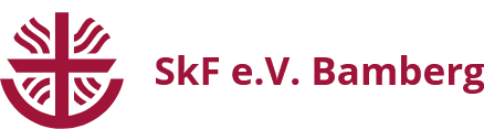 Auf dem Logo des SkF e.V. Bamberg sieht man eine rote Schale, in der ein rotes Kreuz mit roten Strahlen steht