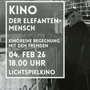 Ein Mann steht vermummt an der Reling eines Schiffes